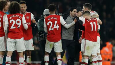 Arsenal manager Mikel Arteta, right, celebrates with his players. AP