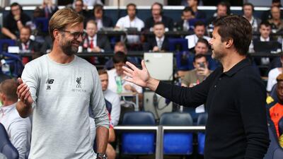 Liverpool manager Jurgen Klopp (L) greets Tottenham Hotspur manager Mauricio Pochettino. Justin Tallis / AFP