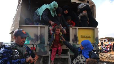 Displaced Iraqis from Mosul arrive at the Hamam Al Alil camp on March 20, 2017, as government forces continue their offensive to retake the western parts of the city from ISIL fighters. Ahmad Al Rubaye/AFP