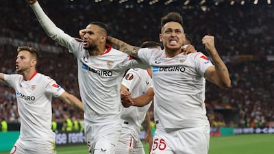 Sevilla's Youssef En-Nesyri and Lucas Ocampos celebrate after AS Roma's Gianluca Mancini scored an own goal. Reuters