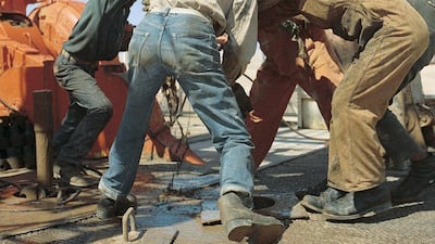 Oil workers on a drilling rig in 1968. Adnoc Drilling is now the largest drilling company in the Middle East, with a fleet of 96 rigs. Courtesy Adnoc Drilling