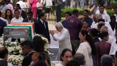 Reserve Bank of India governor Shaktikanta Das, centre, pays homage to Indian business leader Ratan Tata, who died on Wednesday night, in the lawns of the National Centre for the Performing Arts, in Mumbai. AP