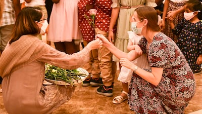 Flowers are placed before the sermon in Abu Dhabi. Khushnum Bhandari / The National