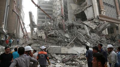 Rescue crews work at the site of the 10-storey building that collapsed in Abadan. Reuters