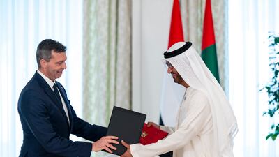 Dr Sultan Al Jaber, Minister of Industry and Advanced Technology and UAE special envoy to Germany, and Markus Steilemann, chief executive of German chemicals manufacturer Covestro, exchange a Memorandum of Understanding, at Al Shati Palace. Abdulla Al Bedwawi / UAE Presidential Court
