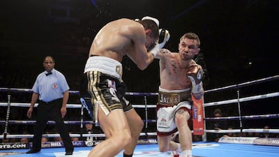 British boxer Carl Frampton, right, gives a right to his fellow countryman Scott Quigg during their unified IBF & WBA super-bantamweight title bout at Manchester Arena in Manchester Saturday, Feb. 27, 2016. (Nick Potts/PA via AP) UNITED KINGDOM OUT, NO SALES, NO ARCHIVE
