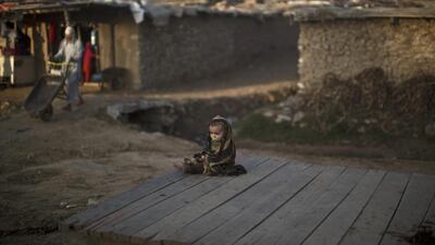 An Afghan refugee child sits on roadside in a poor neighbourhood on the outskirts of Islamabad, Pakistan. Pakistan hosts over 1.6 million registered Afghans, the largest and most protracted refugee population in the world, according to the UN refugee agency. Muhammed Muheisen / AP Photo
