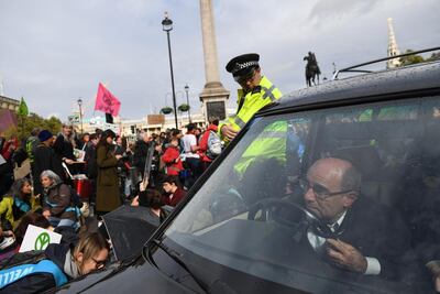 A man drives a hearse as Extinction Rebellion protesters gather in Trafalgar Square on October 7, 2019 in London, England. Chris J Ratcliffe/Getty Images