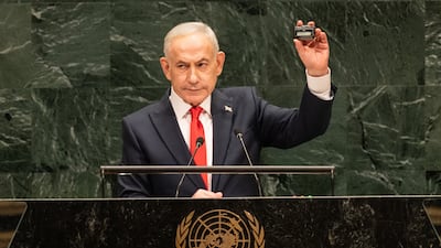 Israel's Prime Minister Benjamin Netanyahu holds a pager similar to what were altered by Israeli intelligence to eliminate many Hezbollah fighters as a reminder of Israel capabilities in science and technology while speaking at UNGA in New York. EPA