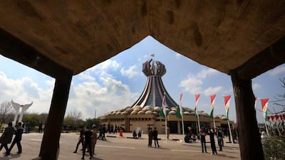 Iraqi Kurds visit at a monument for the victims who were killed in a gas attack by former Iraqi president Saddam Hussein in 1988 during 26th anniversary of the attack in the Kurdish town of Halabja.