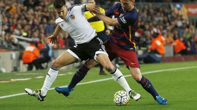 Barcelona’s Ivan Rakitic fights for the ball against Valencia’s Santi Mina. REUTERS/Albert Gea