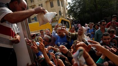 Egyptians jostle to buy subsidised sugar from a government truck in Cairo. Amr Abdallah Dalsh / Reuters