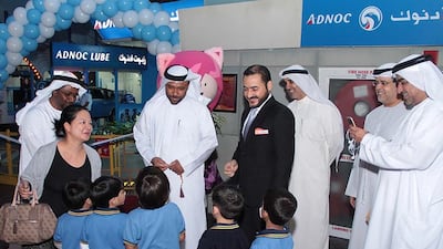 Adnoc Distribution chief executive Abdulla Salem Al Dhaheri, third from left, greets kids during an inauguration ceremony at Kidzania in Dubai Mall. Courtesy ADNOC