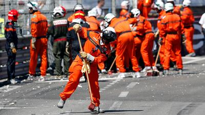 The race, however, was not without its share of mishaps. Here, the safety staff members clear debris after the car of Williams' Pastor Maldonaldo crashed. The Venezuelan was forced to retire. Stefano Rellandini / Reuters