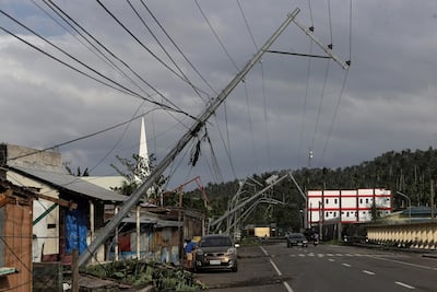 Pylons are knocked over by Typhoon Kammuri in the town of Camalig on Tuesday. Nino Luces / Reuters