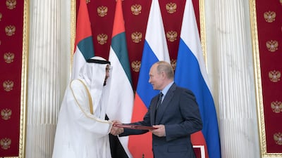 Sheikh Mohammed bin Zayed, Crown Prince of Abu Dhabi and Deputy Supreme Commander of the UAE Armed Forces (left) and Vladimir Putin, President of Russia, exchange documents after the signing of a memorandum of understanding, at the Kremlin. Mohamed Al Hammadi / Crown Prince Court - Abu Dhabi