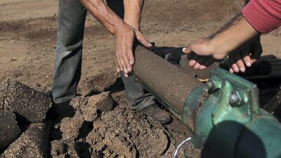 Gazan Entrepreneur Project Turns Olive Waste into a Valuable Resource. The team uses its machine to produce green cakes. Photo by Muhammad Shehada