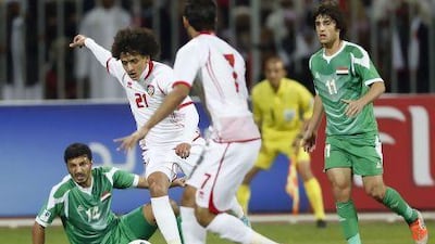 UAE's Omar Abdulrahman (21) prepares to kick the ball to score a goal past Iraq's Salam Shaker (L) during their Gulf Cup Tournament final soccer match on Friday. UAE won in extra time, 2-1.
