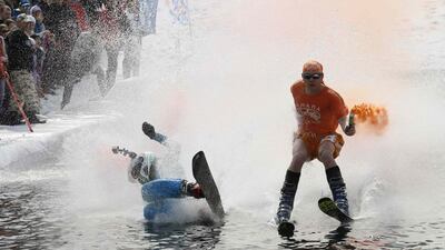 A skier and a snowboarder fall into the pool at the Gornoluzhnik amateur ski event in Siberia. Ilya Naymushin / Reuters / April 20, 2014