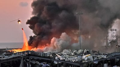 A helicopter puts out a fire at the scene of an explosion at the port of Lebanon's capital Beirut on August 4, 2020. AFP