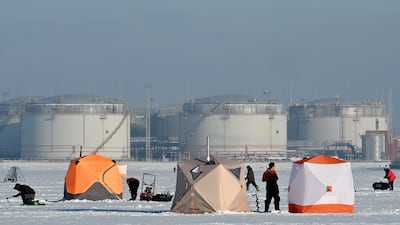 Russian fishermen fish on the ice-covered Gulf of Finland in front of the oil terminal in the port of Saint Petersburg. AFP