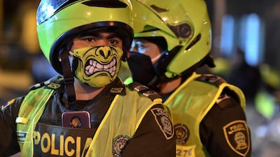 Police officers use face masks as a preventive measure against the spread of the new coronavirus in Cali, Colombia. AFP