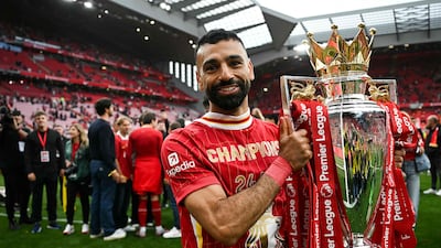 Liverpool's Egyptian star Mohamed Salah celebrates with the Premier League trophy. AFP