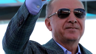 Turkey's President Recep Tayyip Erdogan gestures as he addresses his supporters in Bursa, Turkey, Sunday, Aug. 4, 2019. Erdogan has renewed a pledge for a cross-border military operation into northeastern Syria and said: "We've entered Afrin, Jarablus, al-Bab. Now we will enter the east of the Euphrates." (Presidential Press Service via AP, Pool)