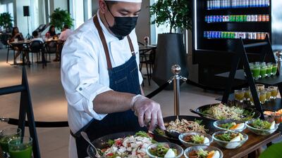 Chef Tristan prepares Friday brunch at the 2020 Club by Emaar at Expo 2020 Dubai. The staff serve guests at the stations