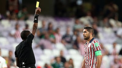 Guadalajara's Jair Pereira is shown a yellow card. Reuters
