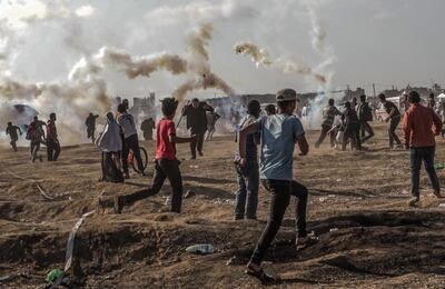 Palestinian protesters observing Nakba Day this year run for cover from Israeli tear-gas in the east of Gaza Strip. Mohammed Saber / EPA