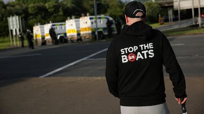 A man wears a 'Stop the Boats' hoody, referring to vessels crossing the English Channel loaded with migrants. Reuters