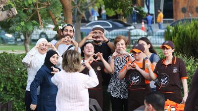Guests pose with staff members with Down syndrome at a recently opened restaurant in Damascus. The 'Sucette' restaurant is the first in Syria to be staffed with people with Down syndrome. EPA
