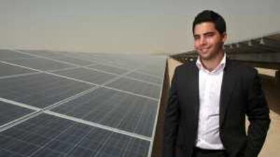 Ayham Mkalalati stands next to Masdar's 10MW solar voltaic panels, which he says work with a good average 75 per cent efficiency.