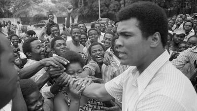 In this September 17, 1974, file photo, Muhammad Ali is greeted in downtown Kinshasa, Zaire. Ali is in Zaire to fight George Foreman. AP Photo