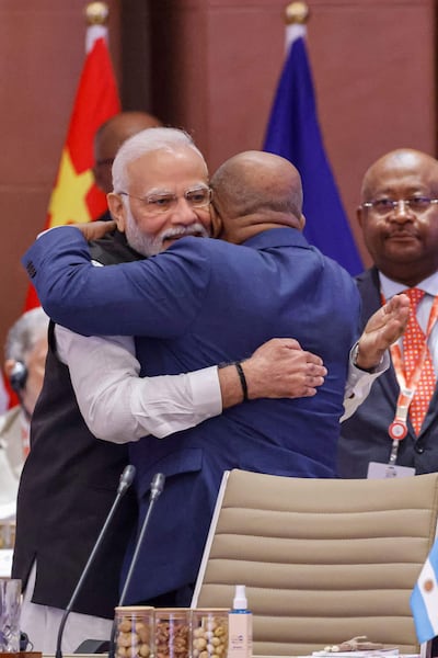 African Union Chairman and Comoros President Azali Assoumani, (right) and India's Prime Minister Narendra Modi embrace at the G20 Leaders' Summit in New Delhi on Saturday. AFP