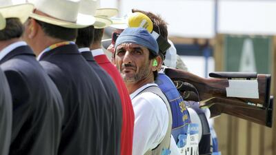 Sheikh Ahmed looks at the scoreboard before the men's double trap final of the Athens 2004 Olympic Games in Athens, August 17, 2004. Reuters