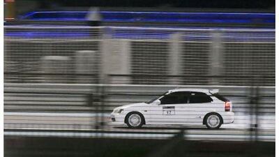 A modified Honda Civic brakes into a corner at Yas Marina Circuit. Pawel Dwulit / The National