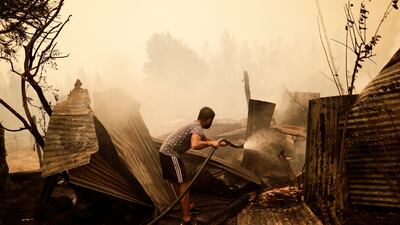 A resident tries to put out the fire