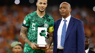 Nigeria defender William Troost-Ekong holds the Golden Ball award while standing next to President of the Confederation of African Football (CAF) Patrice Motsepe during prize giving ceremony. AFP