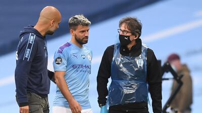 Manchester City manager Pep Guardiola talks to his forward Sergio Aguero as he walks off injured. EPA