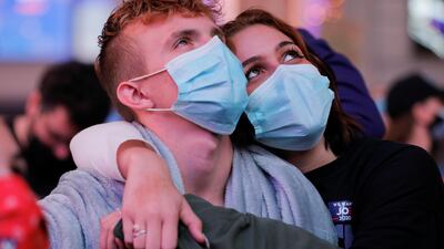 People watch the speeches by Joe Biden and Kamala Harris, at Times Square in New York City. Reuters