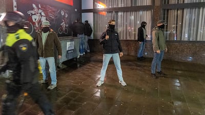 Dutch riot police respond after violence in Amsterdam on November 11. People have been filmed throwing fireworks at a tram in another incident in the city. Reuters