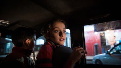 Yara and her brother waiting for their father to return with schwarma as an evening treat after a recent conflict ended.