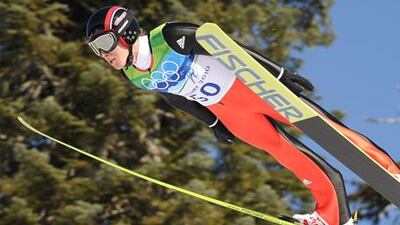 Simon Amman jumped 144 metres to capture gold for the second time at the Winter Olympics.