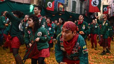 Members of a team of orange throwers 'I Tuchini del Borghetto' partake in the carnival. AFP