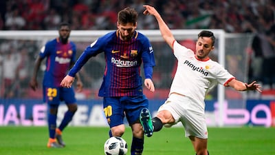 Barcelona's Lionel Messi, left, vies with Sevilla midfielder Pablo Sarabia during their Copa del Rey final at the Wanda Metropolitano stadium in Madrid. Pierre-Philippe Marcou / AFP