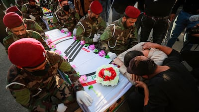 Iraqis cry next to the coffin of a fighter killed in a US strike during a funeral in Baghdad in November. AFP