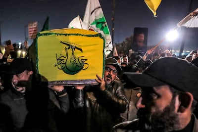 A militia member's coffin is shrouded in the flag of Harakat Al Nujaba. AFP