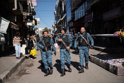Members of the security forces patrol the market in Sweida. Hasan Belal for The National